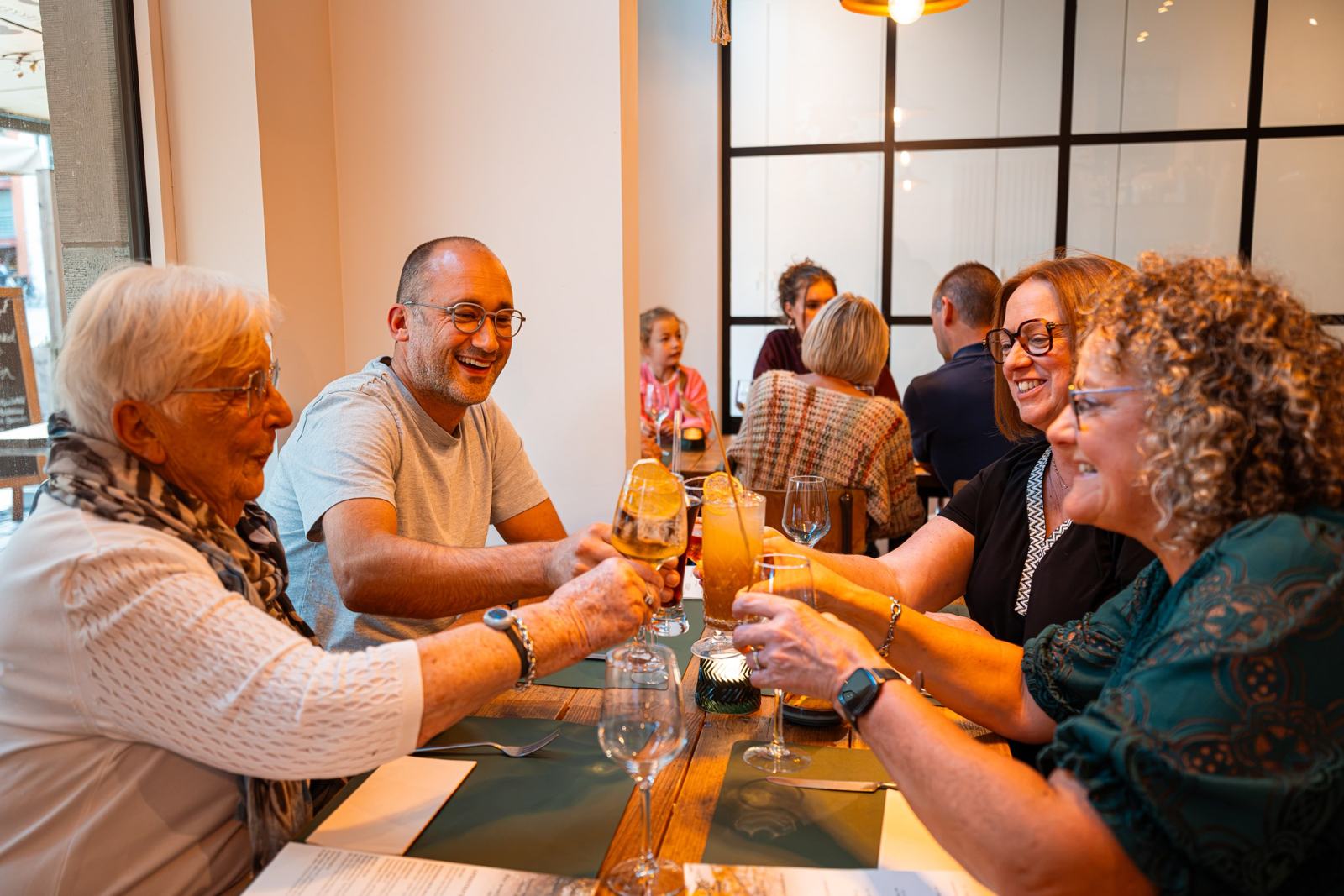 Gasten klinken aan tafel in restaurant Goeste in Poperinge